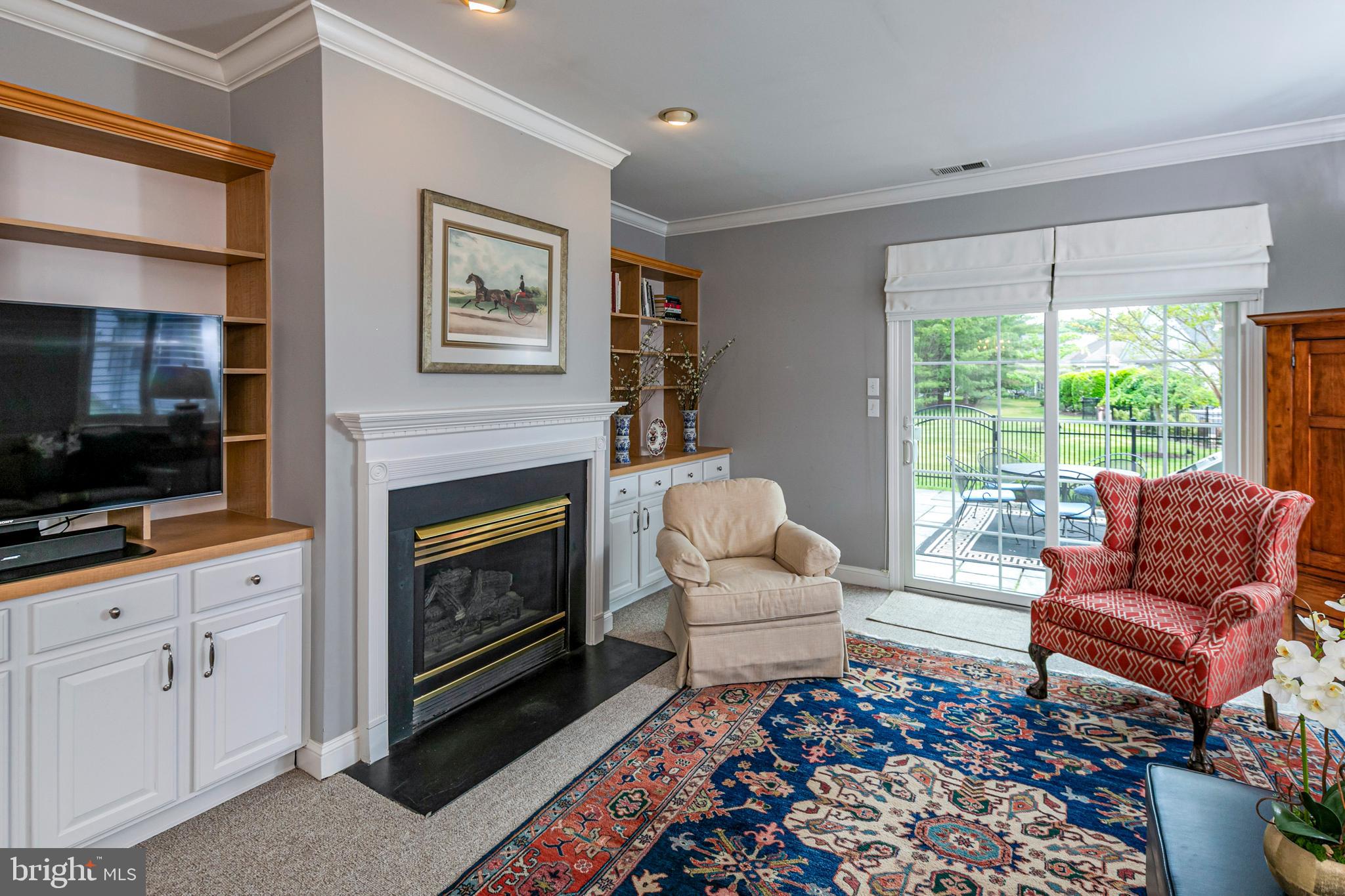 24 Foster Road Pennington, NJ 08534 - Photo 10 of 38 a living room with furniture a flat screen tv and a fireplace