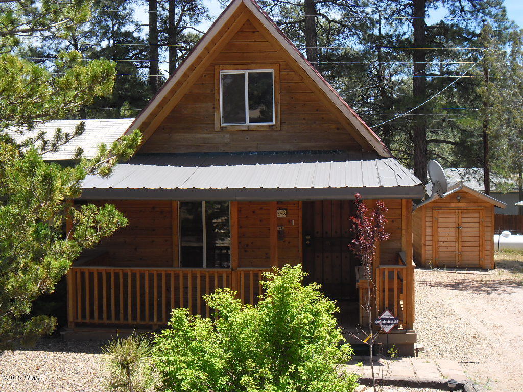 3463 Quail Run Road Overgaard, AZ 85933 - Photo 1 of 37 a front view of a house with garden