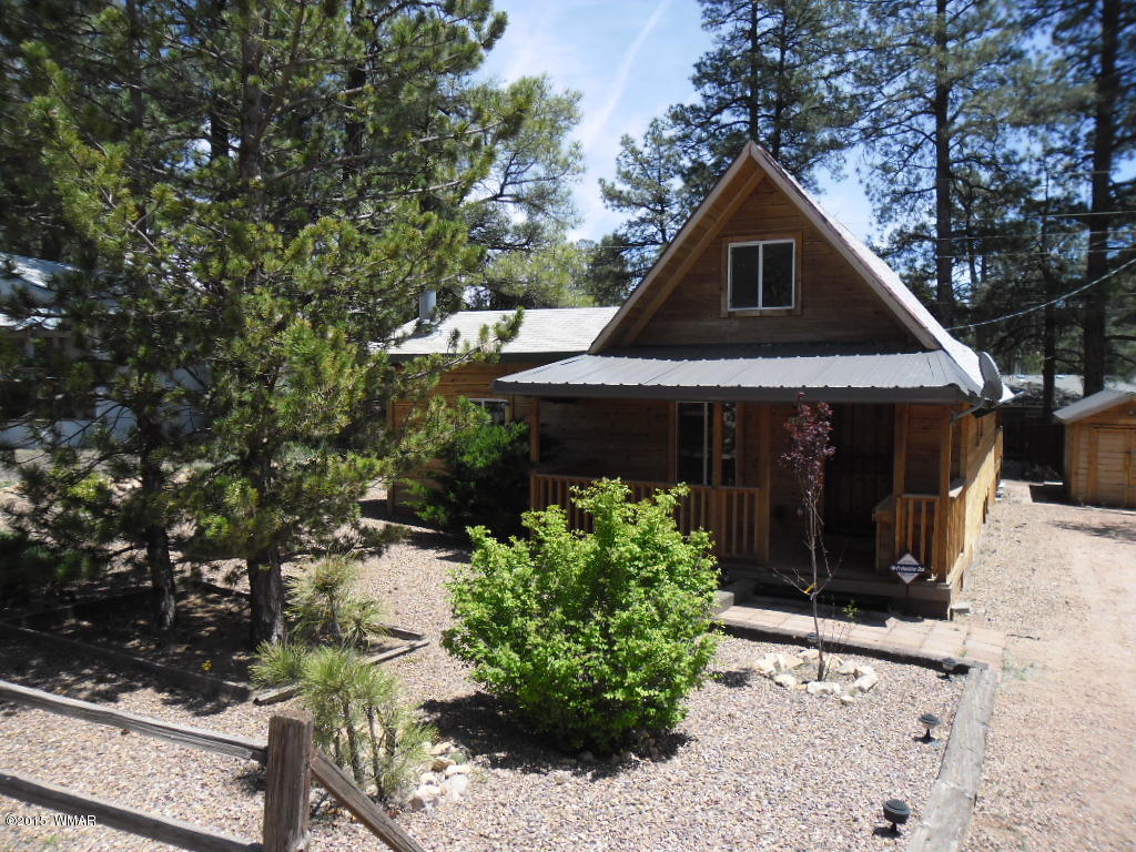 3463 Quail Run Road Overgaard, AZ 85933 - Photo 3 of 37 a front view of a house with a yard