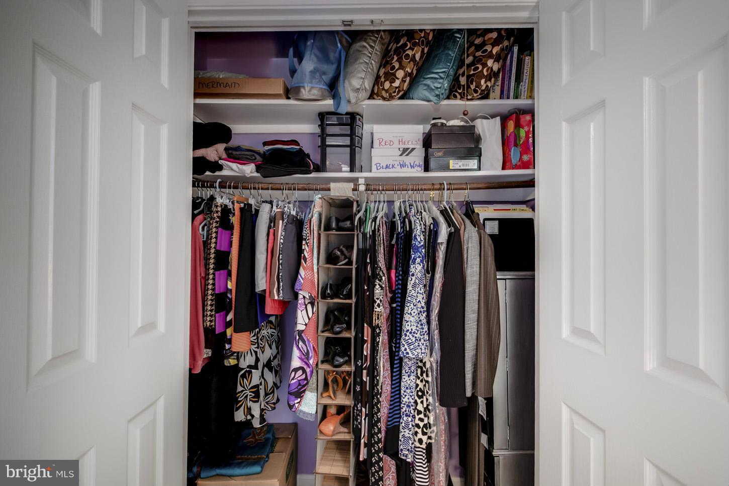 1233 Portner Road Alexandria, VA 22314 - Photo 22 of 29 a view of walk in closet with clothes and shoes