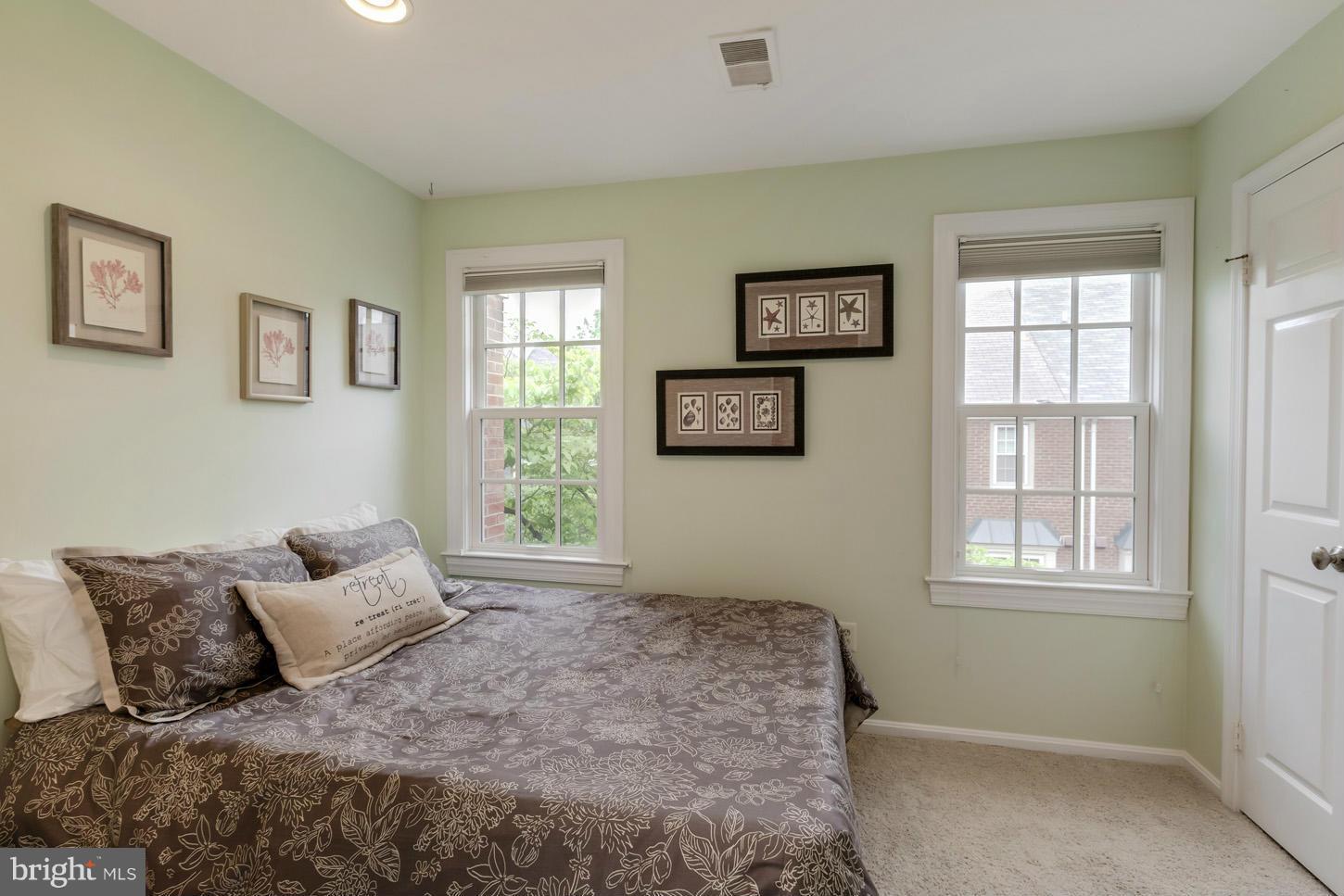 1233 Portner Road Alexandria, VA 22314 - Photo 25 of 29 a bed sitting in a bedroom next to a window