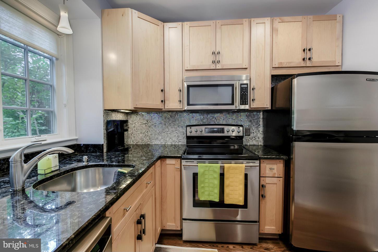 1233 Portner Road Alexandria, VA 22314 - Photo 4 of 29 a kitchen with stainless steel appliances granite countertop a sink stove and refrigerator