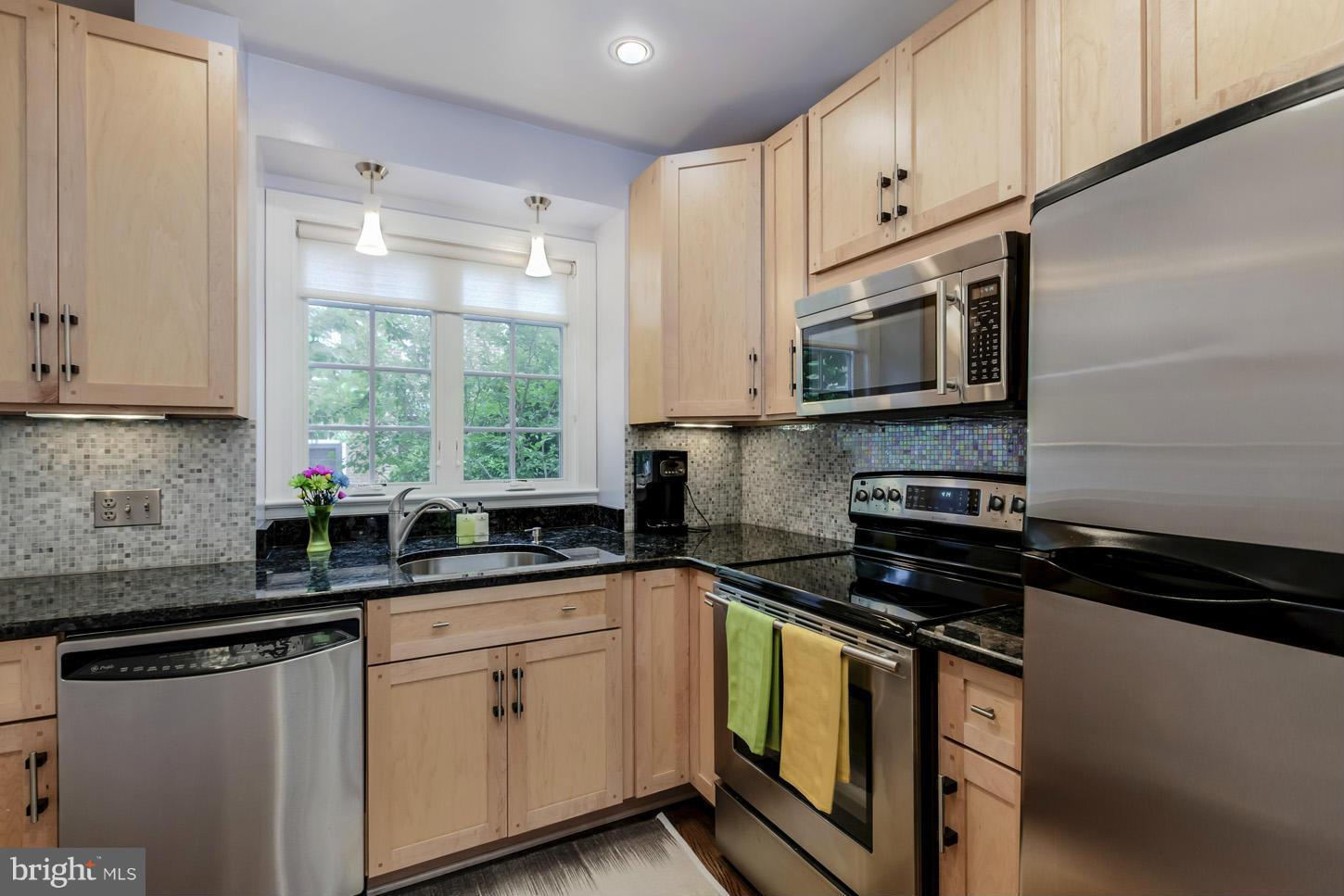 1233 Portner Road Alexandria, VA 22314 - Photo 5 of 29 a kitchen with stainless steel appliances granite countertop white cabinets granite counter tops and a window