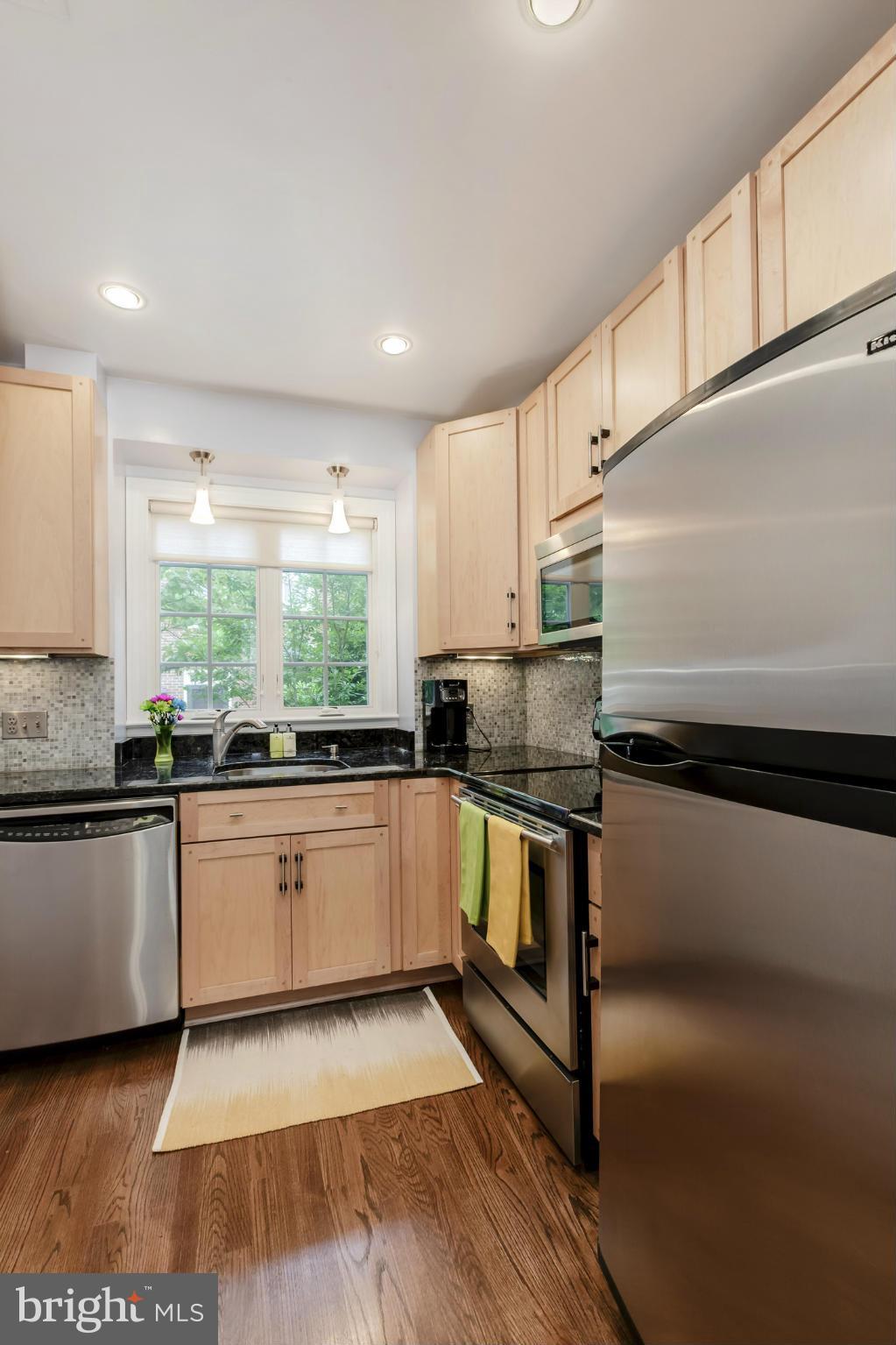 1233 Portner Road Alexandria, VA 22314 - Photo 6 of 29 a kitchen with stainless steel appliances granite countertop a stove a sink and a microwave