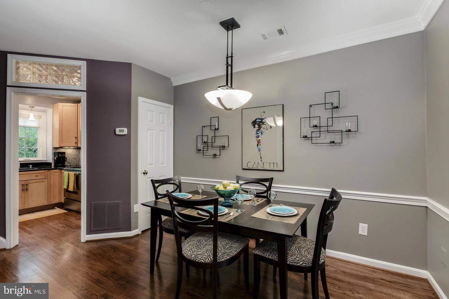 1233 Portner Road Alexandria, VA 22314 - Photo 8 of 29 a view of a dining room with furniture wooden floor and a chandelier