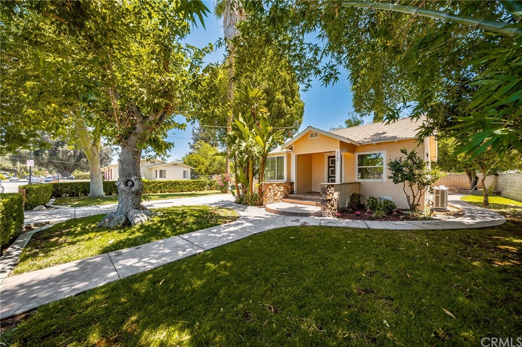 5980 Meadowbrook Lane Riverside, CA 92504 - Photo 1 of 1 a front view of a house with swimming pool and yard