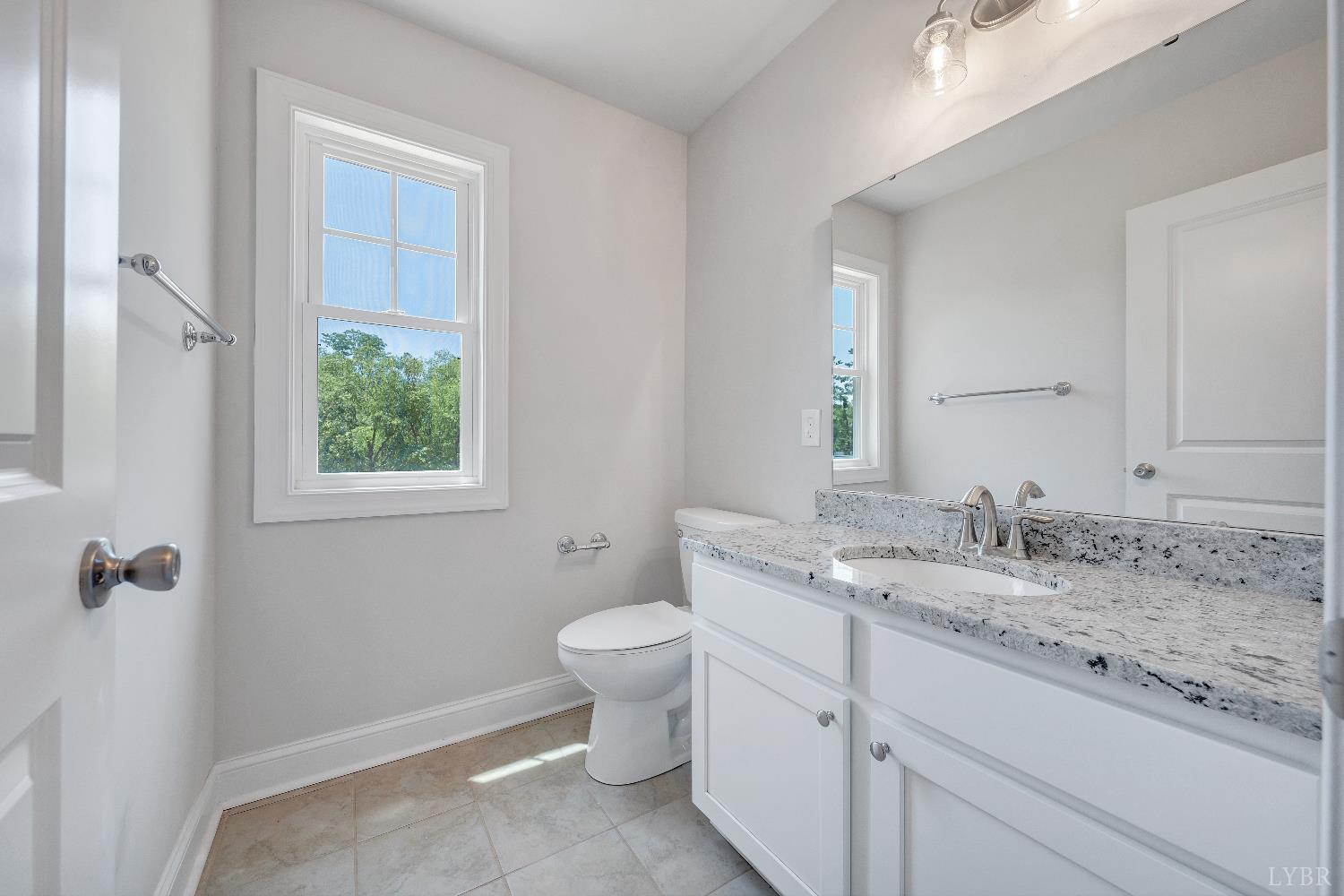 23 Elk Crk Road Forest, VA 24551 - Photo 19 of 22 a bathroom with a granite countertop sink mirror vanity and toilet