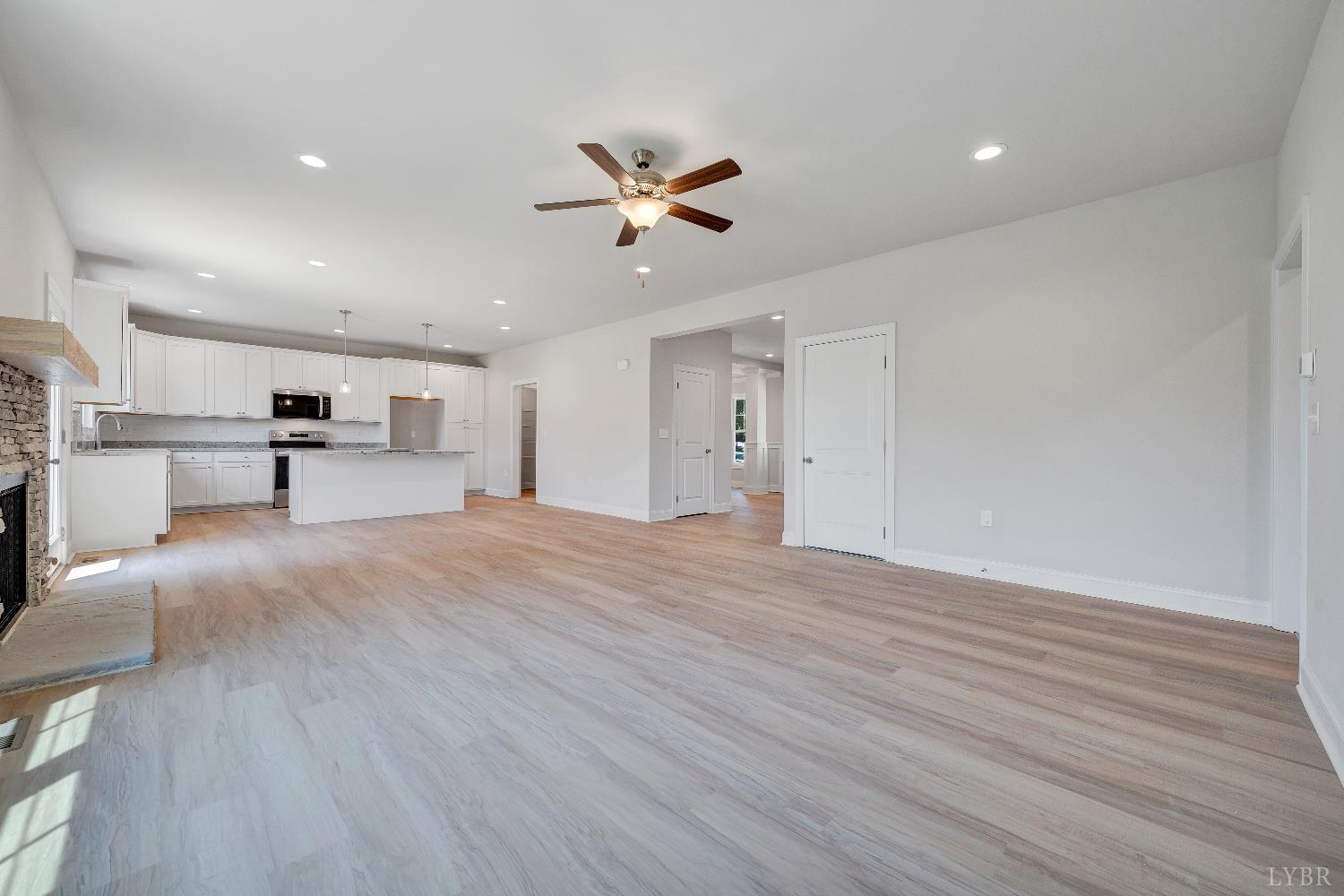 23 Elk Crk Road Forest, VA 24551 - Photo 5 of 22 a view of a living room a stove and a ceiling fan