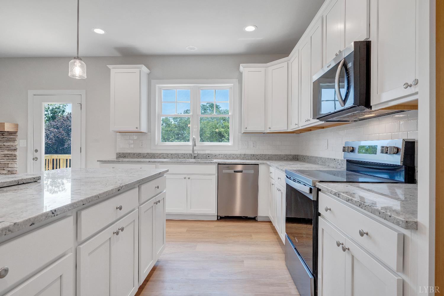 23 Elk Crk Road Forest, VA 24551 - Photo 8 of 22 a kitchen with granite countertop white cabinets stainless steel appliances a sink and a window