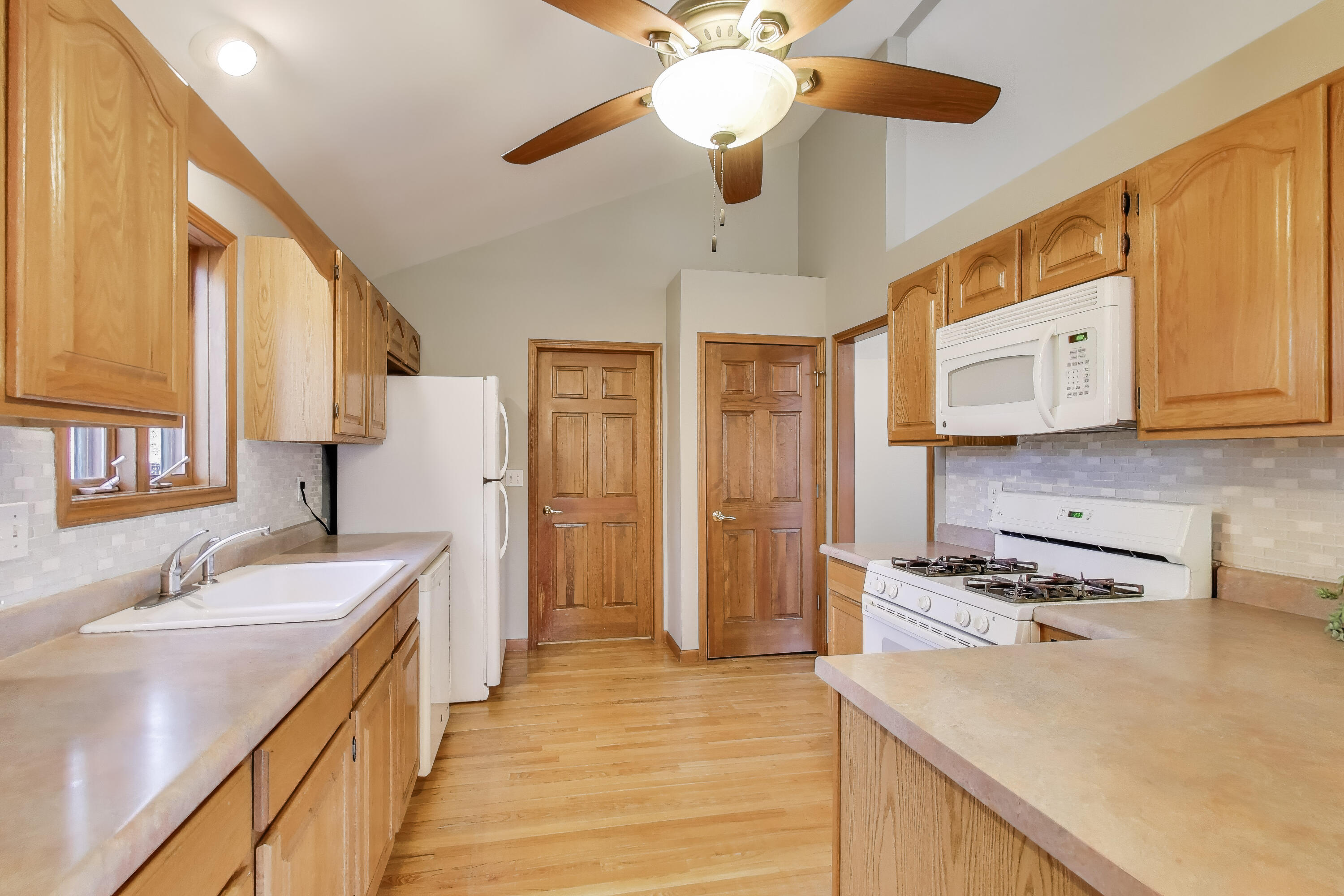 1642 Commodore Lane Chesterton, IN 46304 - Photo 11 of 34 a kitchen with stainless steel appliances granite countertop a sink a stove a refrigerator cabinets and wooden floor