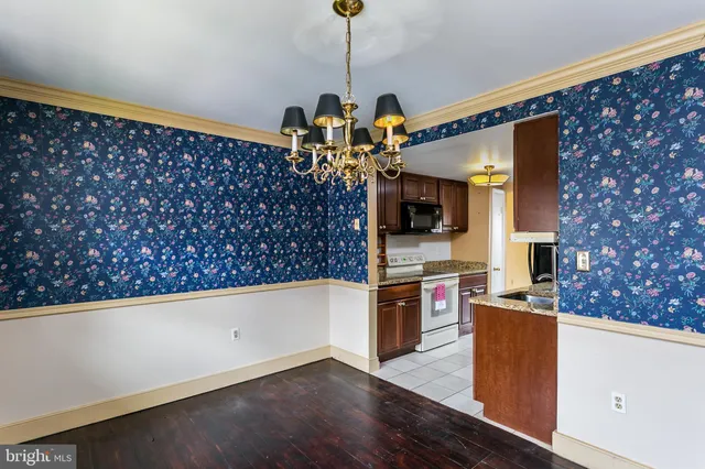 a kitchen with stainless steel appliances granite countertop a stove and a refrigerator