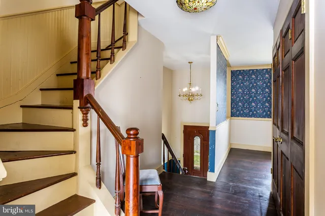a view of an entryway with wooden floor and stairs