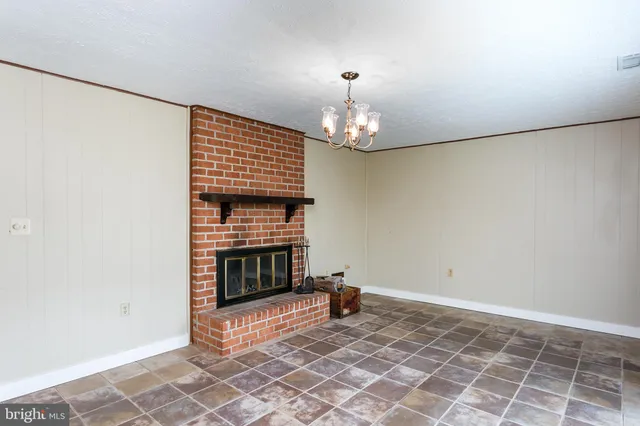 a view of an empty room with a fireplace