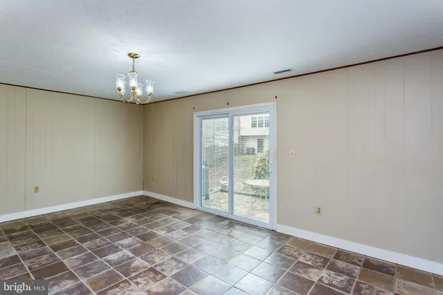 a view of an empty room with a chandelier