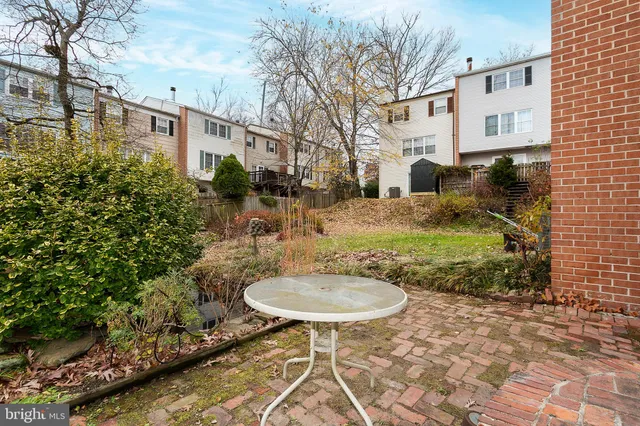 a backyard of a house with yard and outdoor seating