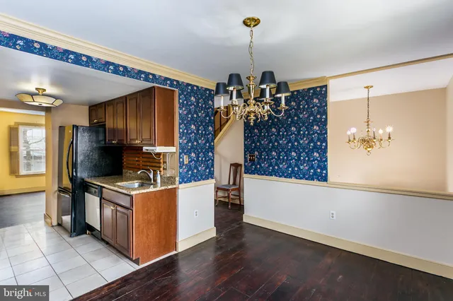 a kitchen with stainless steel appliances granite countertop a stove and a wooden floors