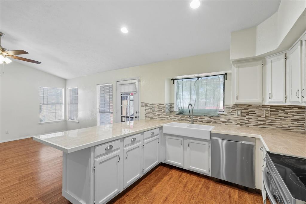 9101 Denver Street Rowlett, TX 75088 - Photo 14 of 40 a kitchen with a sink stove and cabinets