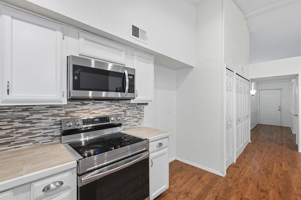 9101 Denver Street Rowlett, TX 75088 - Photo 16 of 40 a kitchen with a stove and a microwave