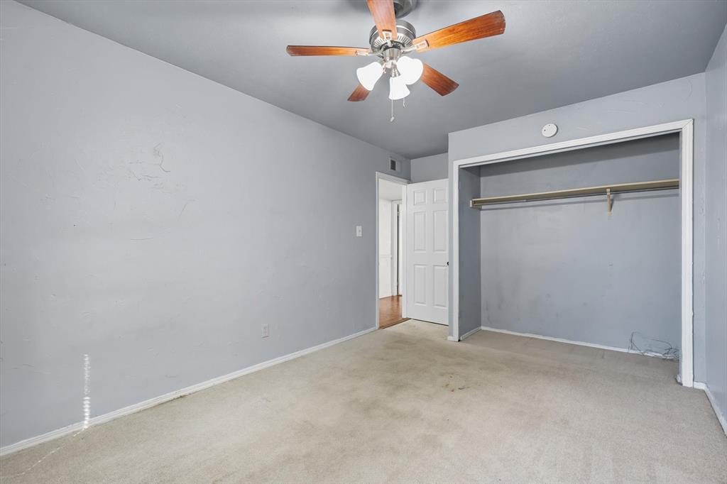 9101 Denver Street Rowlett, TX 75088 - Photo 28 of 40 an empty room with closet and a chandelier fan