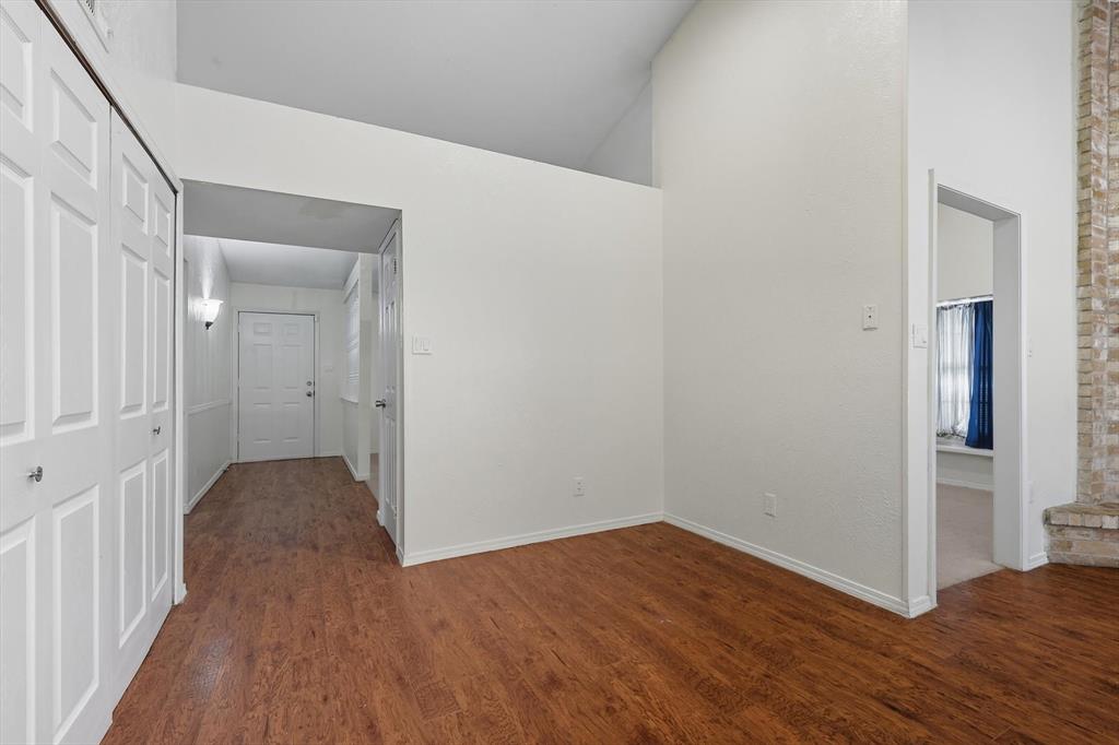 9101 Denver Street Rowlett, TX 75088 - Photo 10 of 40 a view of a hallway with wooden floor and closet area