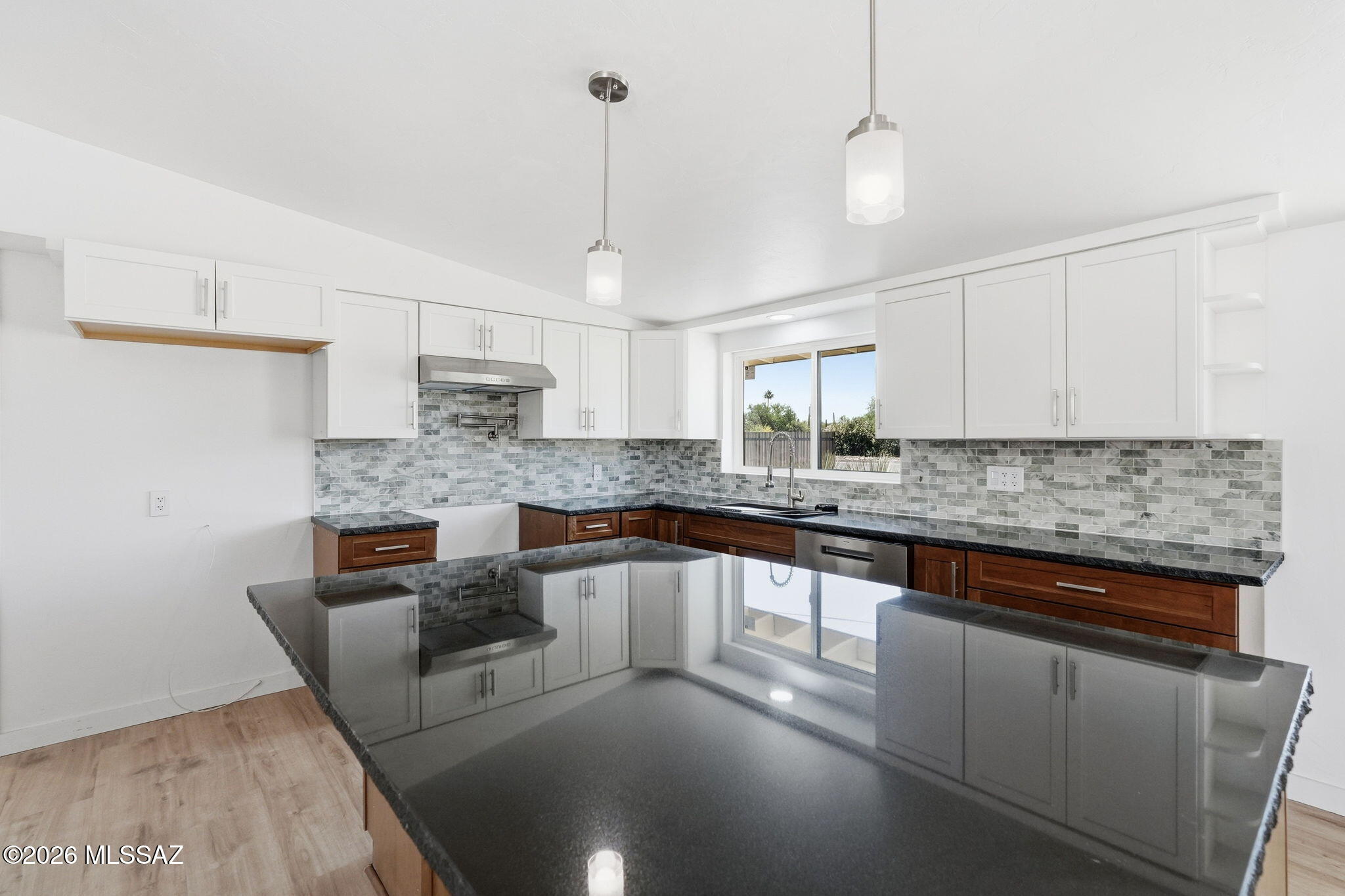 950 West Ina Road Tucson, AZ 85704 - Photo 12 of 54 a kitchen with stainless steel appliances granite countertop a sink a stove and a wooden floors