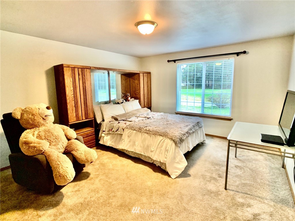 8306 173rd Avenue Southwest Rochester, WA 98579 - Photo 12 of 40 a bed sitting in a bedroom next to a window