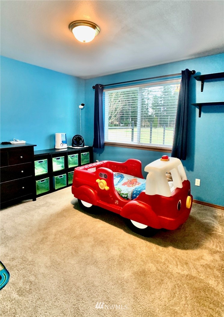 8306 173rd Avenue Southwest Rochester, WA 98579 - Photo 13 of 40 a bedroom with a bed and window