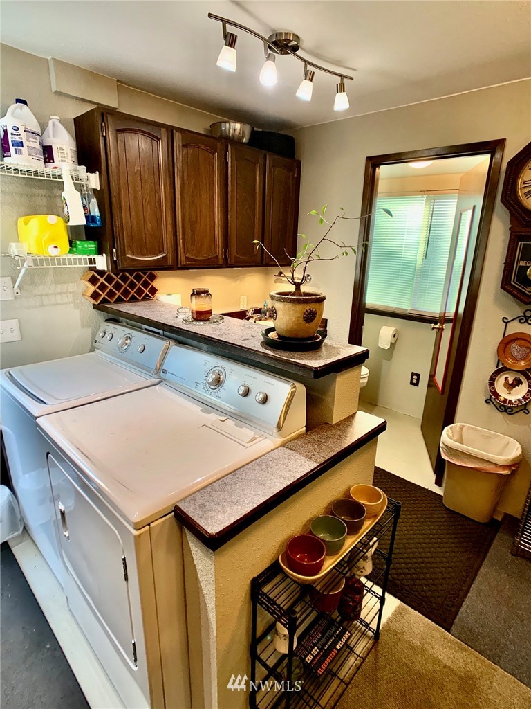 8306 173rd Avenue Southwest Rochester, WA 98579 - Photo 29 of 40 a kitchen with a sink appliances and cabinets