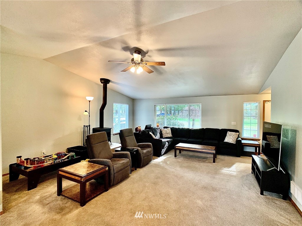 8306 173rd Avenue Southwest Rochester, WA 98579 - Photo 4 of 40 a living room with furniture ceiling fan and a rug