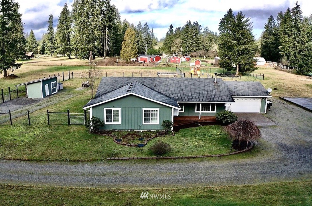 8306 173rd Avenue Southwest Rochester, WA 98579 - Photo 34 of 40 a view of house with a yard and potted plants