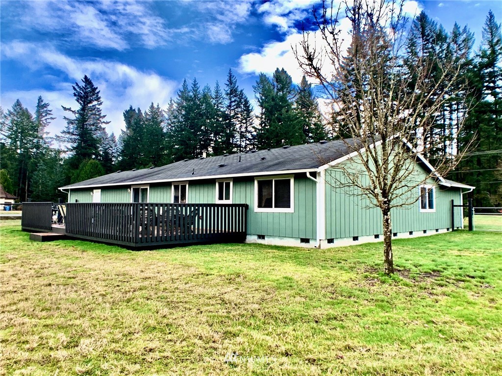 8306 173rd Avenue Southwest Rochester, WA 98579 - Photo 37 of 40 a view of a house with a yard and large trees