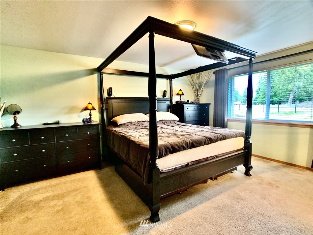8306 173rd Avenue Southwest Rochester, WA 98579 - Photo 9 of 40 a bed room with a bed and a night stand