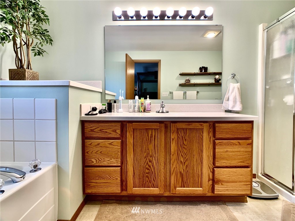 8306 173rd Avenue Southwest Rochester, WA 98579 - Photo 10 of 40 a en suite bathroom with a sink double vanity and a mirror