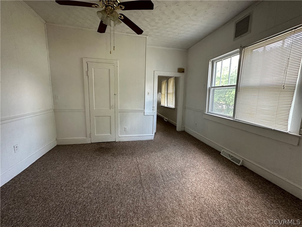 2007 West City Point Road Hopewell, VA 23860 - Photo 3 of 9 en empty room with windows and ceiling fan