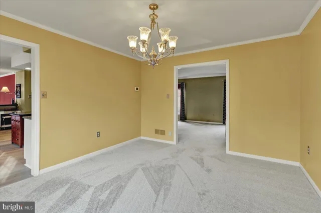 a view of a chandelier in big room and a chandelier fan