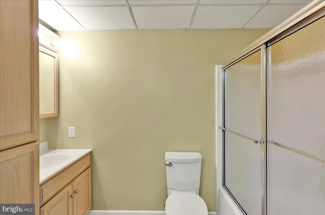 a white toilet sitting next to a bathroom sink