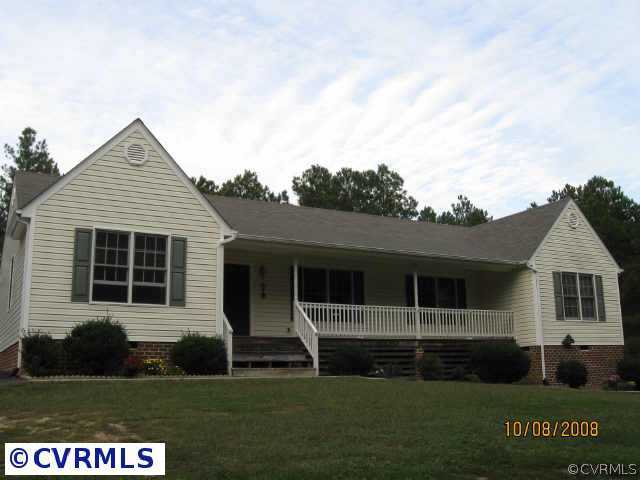 6544 Hair Road Disputanta, VA 23842 - Photo 3 of 5 a front view of a house with a yard