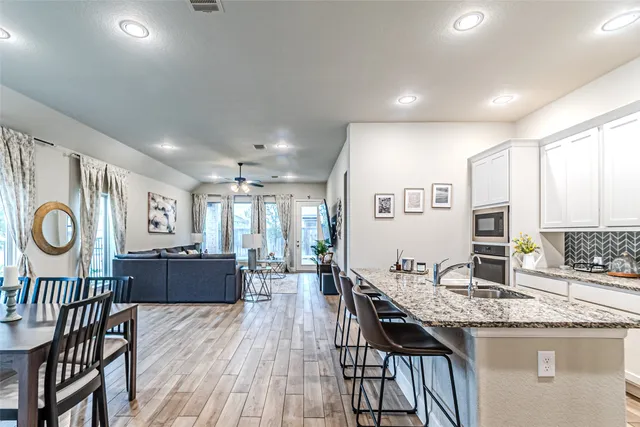 a kitchen with granite countertop a sink and cabinets