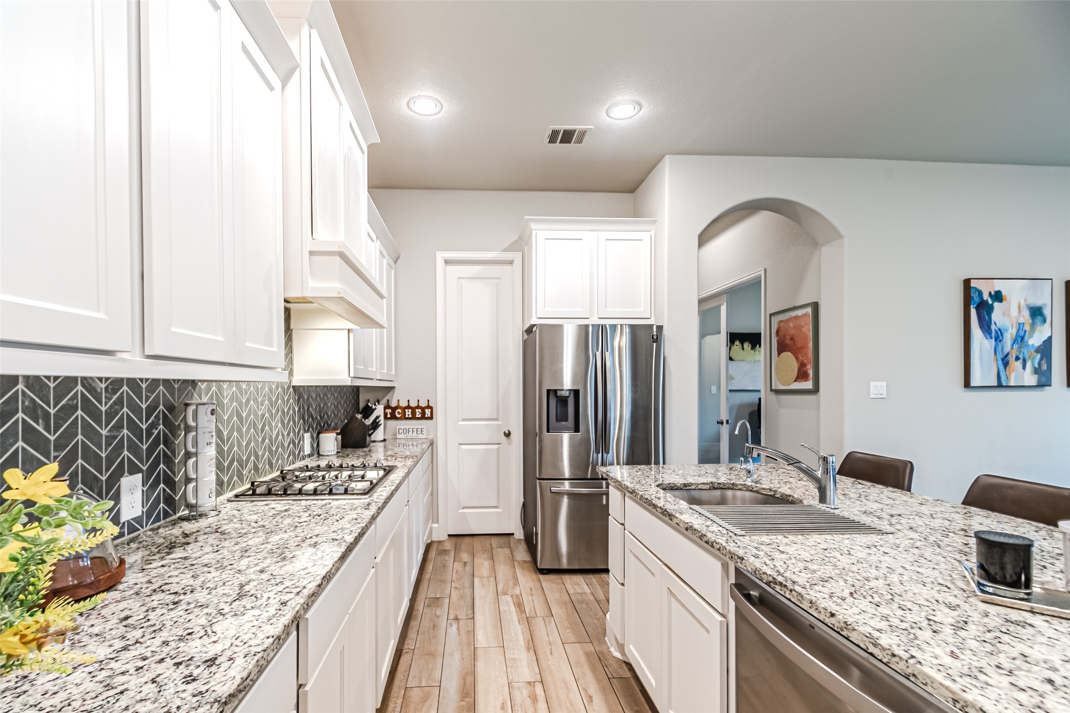 15022 Concho River Way Cypress, TX 77433 - Photo 26 of 50 a kitchen with a refrigerator sink and stove