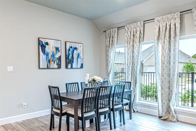 a living room with furniture and large windows