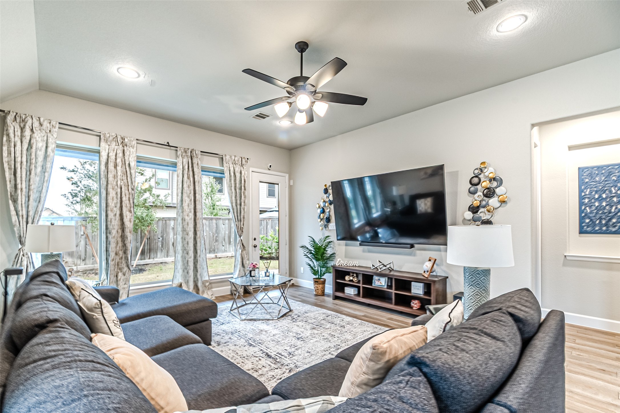 15022 Concho River Way Cypress, TX 77433 - Photo 31 of 50 a living room with furniture and a flat screen tv with wooden floor