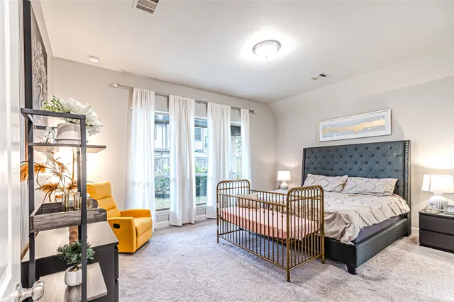 a bedroom with a bed and a lamp