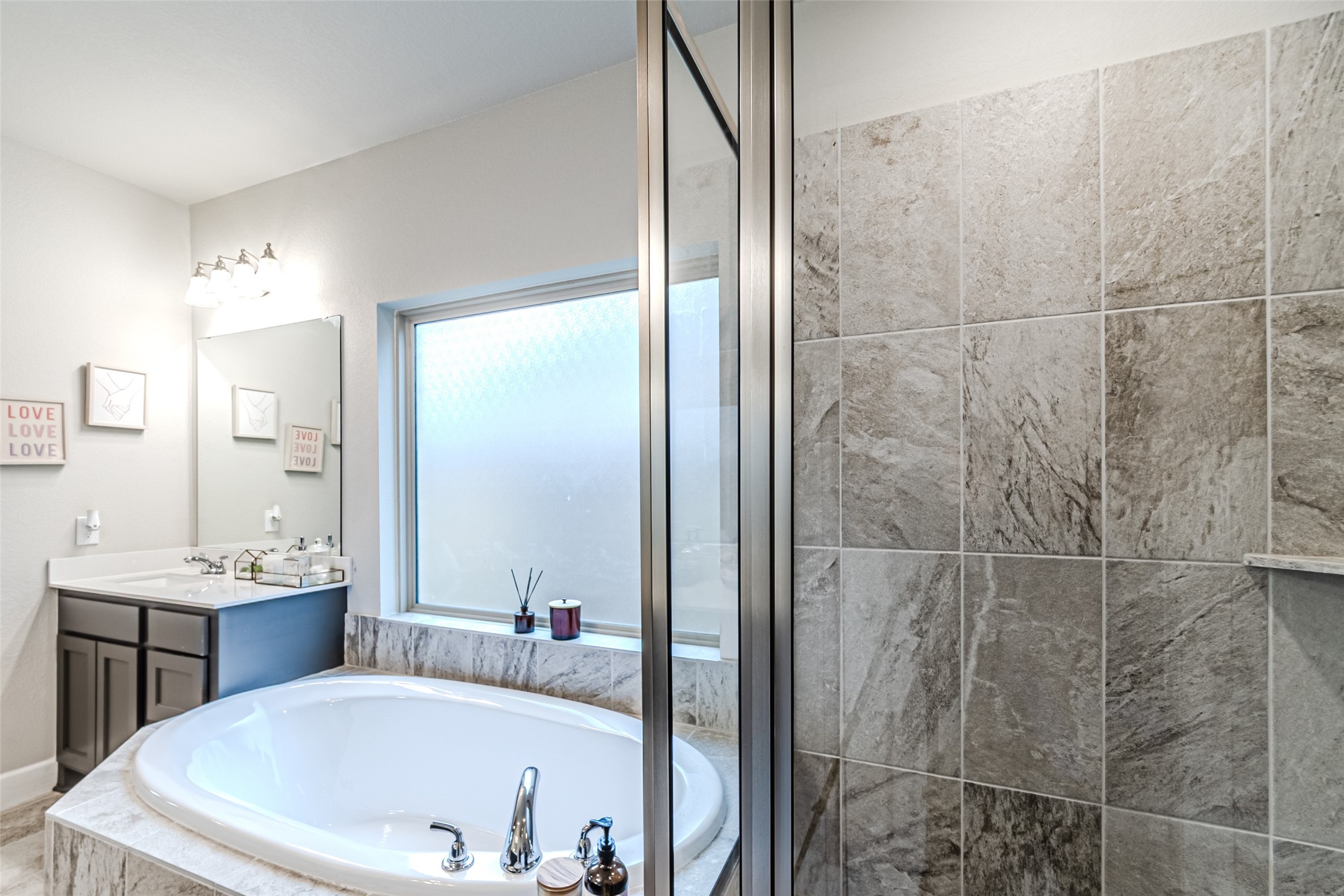 15022 Concho River Way Cypress, TX 77433 - Photo 43 of 50 a bathroom with a tub sink and mirror