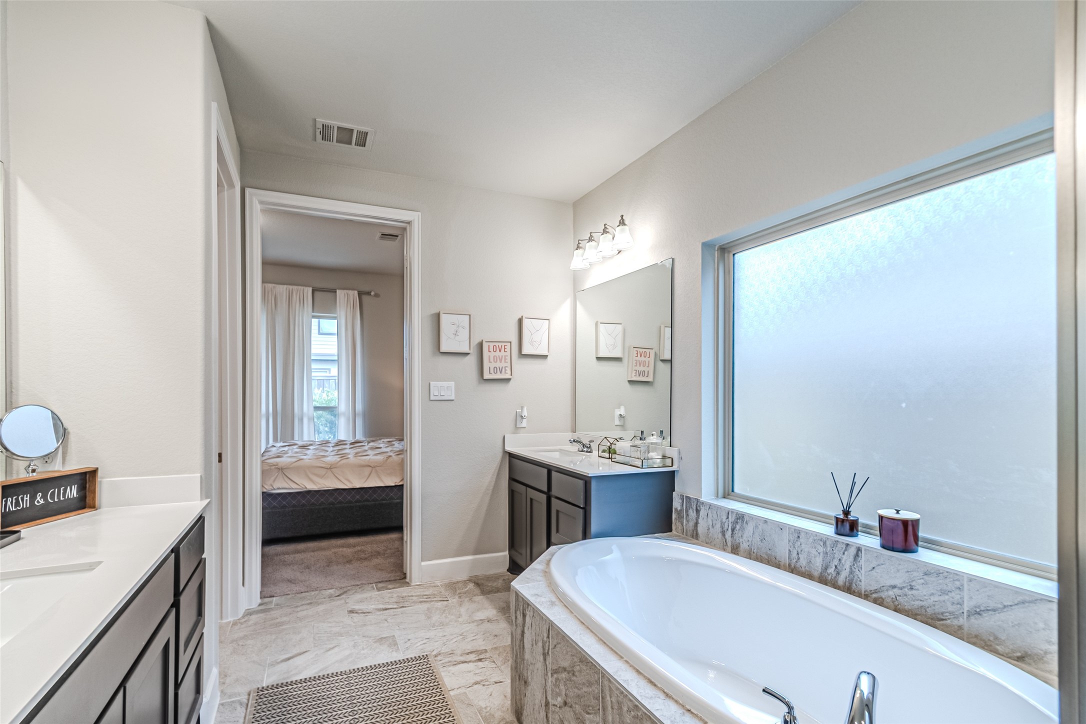 15022 Concho River Way Cypress, TX 77433 - Photo 44 of 50 a en suite bathroom with a granite countertop sink and a mirror