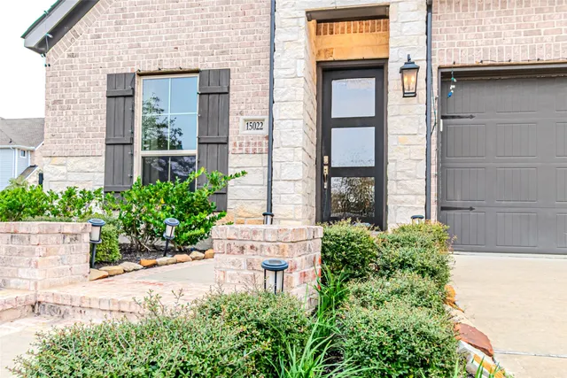 front view of a brick house with a large windows