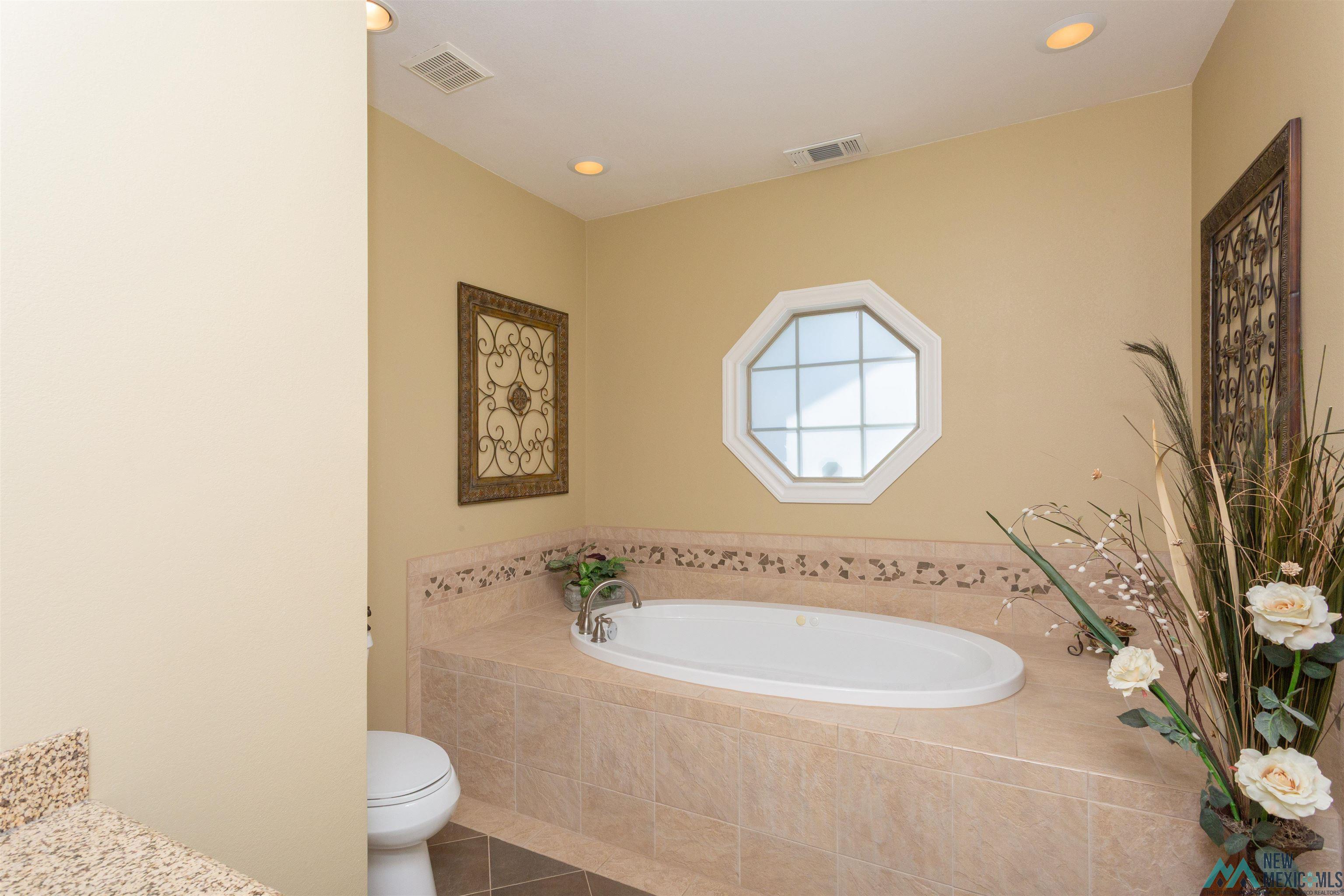 3103 Onate Road Roswell, NM 88201 - Photo 39 of 57 Bathroom with a garden tub, tile patterned floors, recessed lighting, and vanity