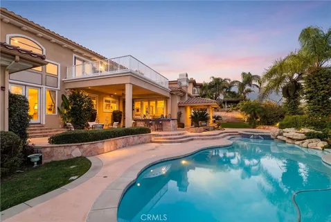 a view of a swimming pool with an outdoor seating