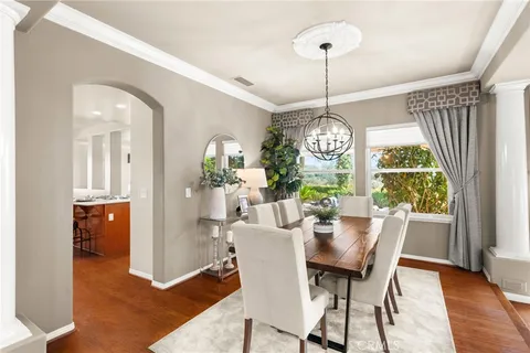 a view of a dining room with furniture wooden floor and chandelier