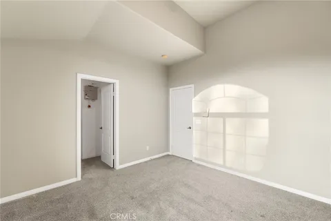 a kitchen with stainless steel appliances granite countertop a refrigerator a sink dishwasher a stove and a dining table with wooden floor