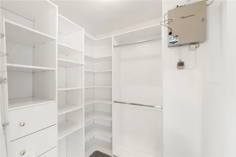 a kitchen with a table chairs refrigerator and cabinets